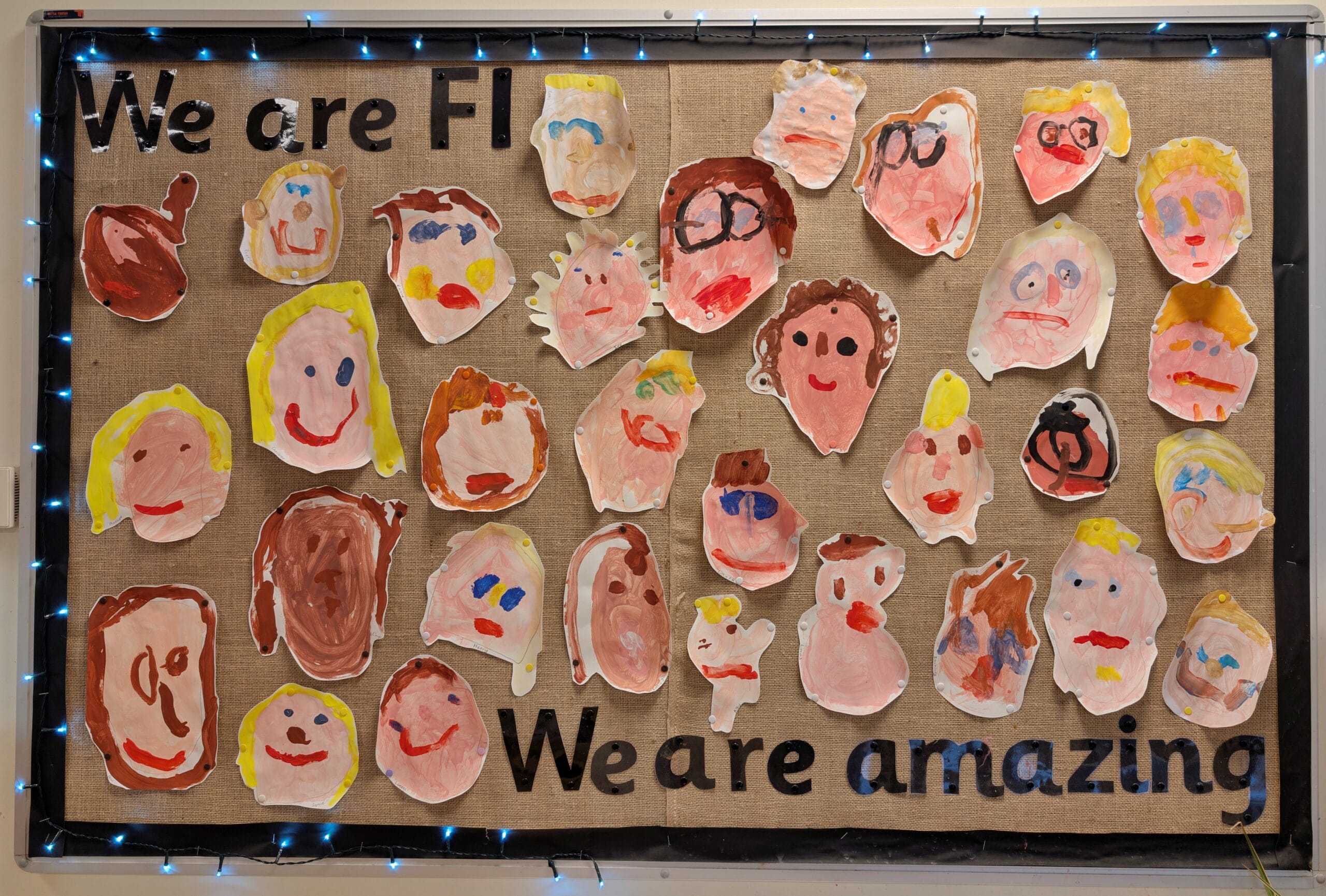 Nursery Class Cork board with paintings of all nursery children